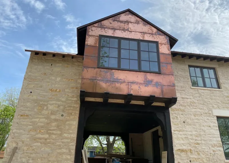 Copper metal panel facade on a stone building for Roof Repair in Goleta